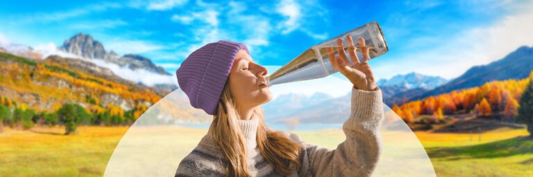 Woman Prioritizing Health and Drinking from Glass Bottle